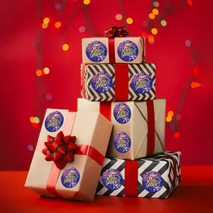 Festive round Happy New Year stickers used for sealing holiday gift boxes and packages