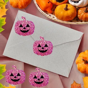 Detail of pink glitter pumpkin stickers on a grey envelope for Halloween décor