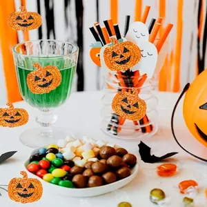 Glittery laser Halloween pumpkin stickers decorating glasses and party snack bowls