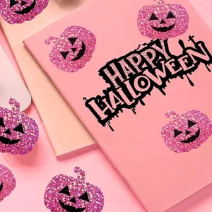 Macro view of glittery pink pumpkin stickers with Happy Halloween script for DIY decor.