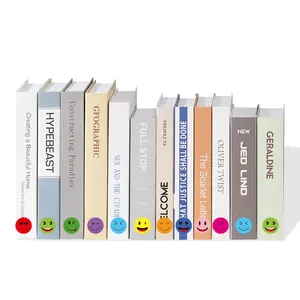 Close-up of various colorful emoji stickers applied as decorative labels on book spines.