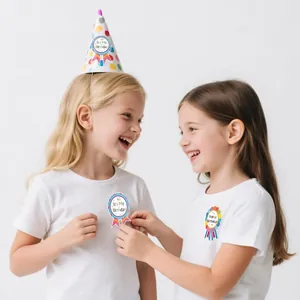 Detailed view of two young girls wearing colorful Happy Birthday award medal stickers