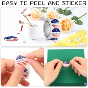 Detail view of patriotic American flag Thank You stickers being applied to a gift box