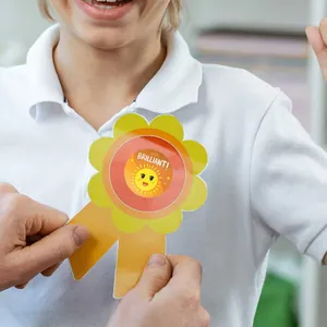 Close-up of a brilliant sun reward sticker on a child's white polo shirt