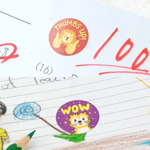 Macro detail view of cute cartoon lion and tiger reward stickers on a student notebook page