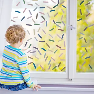 Colorful macaron style confetti wall stickers applied on glass window in kids room.