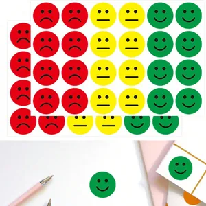 Macro detail of green smiley reward stickers applied to a white paper notebook