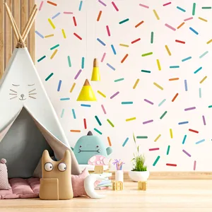 Vibrant macaron-colored sprinkle wall stickers applied in a cozy nursery playroom