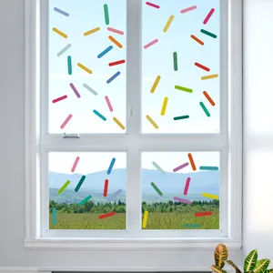 Colorful macaron sprinkle wall stickers applied on glass window with mountain view