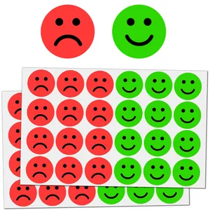 Detailed macro view of red sad and green smiley face emotion reward stickers for children