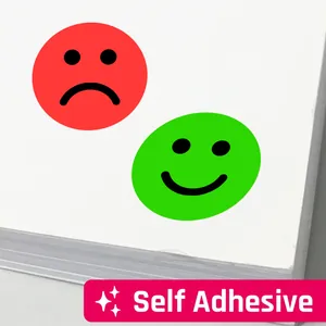 Detailed macro view of green happy and red sad face self-adhesive emotion reward stickers