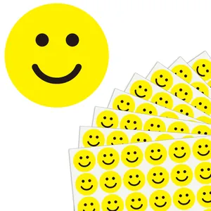 Detailed macro view of yellow smiley face reward stickers and decorative adhesive sheets
