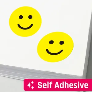 Macro view of vibrant yellow smiley face reward stickers with self adhesive label