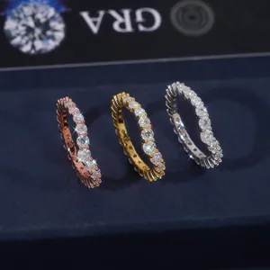 Close-up of three sparkling moissanite eternity bands in rose, gold, and silver colors