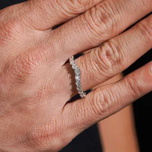 Elegant unisex S925 sterling silver moissanite eternity ring shown worn on a hand