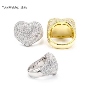 Detailed view of iced-out heart-shaped rings in silver and gold tones