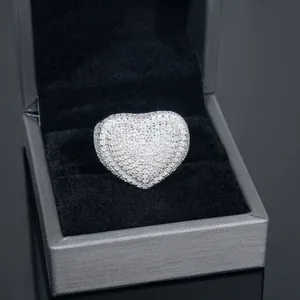 Detailed close-up of a sparkling heart-shaped moissanite ring in a grey jewelry box