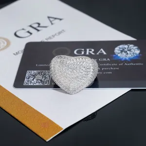 Detailed macro shot of a heart-shaped moissanite pavé ring with GRA authenticity card