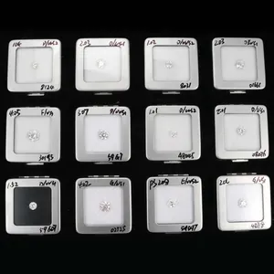 Primo piano di diversi diamanti coltivati in laboratorio taglio brillante in scatole.
