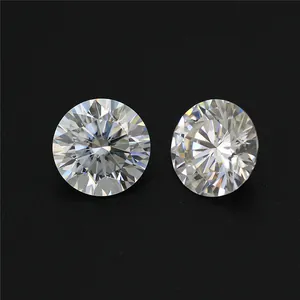Two round brilliant cut H color moissanite loose diamonds on professional black background