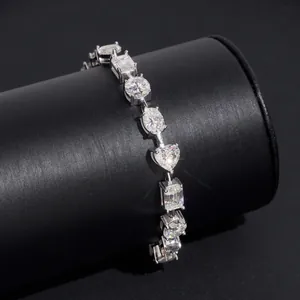Détail macro d'un bracelet tennis en moissanite multi-formes sur présentoir noir.