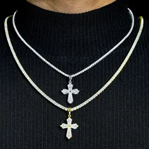 Macro shot of silver and gold Moissanite cross pendants on tennis chains on a black background
