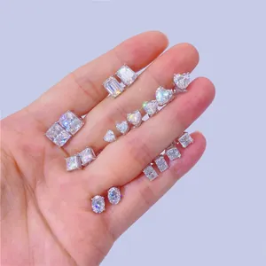 Close-up of various moissanite silver stud earrings in multiple geometric shapes