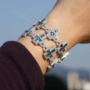 Detailed close-up of S925 silver bracelet with iced out cross and blue moissanite