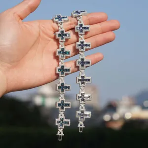 S925 silver iced out cross bracelets with blue moissanite stones held in natural light