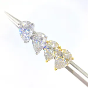 Detailed view of pear-cut moissanite earrings in silver and gold tones