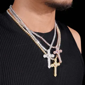 Detail shot of layered iced out S925 silver moissanite cross pendants on a person