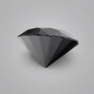 Détail en gros plan des facettes d'une pierre précieuse en moissanite noire brillante