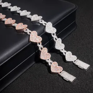 Macro view of heart-shaped moissanite cuban link bracelets with sparkling stone settings