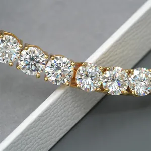 Macro detail of brilliant 10mm round Moissanite stones on a gold tennis chain link