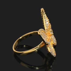 Perfil lateral de un anillo de mariposa bañado en oro con engaste de piedras moissanita