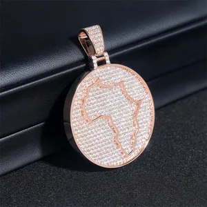 Macro detail of iced-out rose gold Africa map medallion pendant with moissanite stones