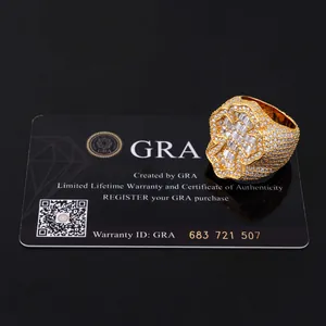 Detailed view of gold plated iced out moissanite ring with GRA certificate card