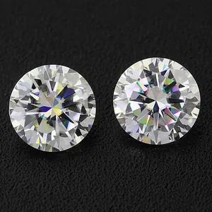 Close-up of two brilliant round D color 3EX cut moissanite loose gemstones on black