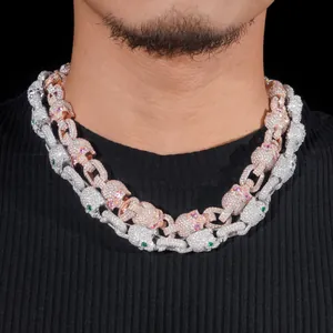 Detail view of iced-out Moissanite skull Cuban link necklaces on a male model neck