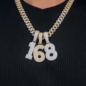 Detailed view of iced-out number pendants 168 on a thick gold and silver cuban link chain