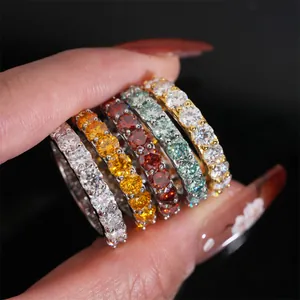 Macro view of several 4mm colorful round moissanite eternity rings set in S925 silver