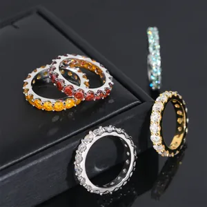 Macro view of colorful round-cut moissanite eternity rings on a black display box