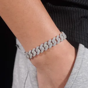 Close-up detail of a 10mm iced-out moissanite Cuban link bracelet worn on wrist