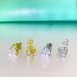 Macro view showing fire of heart-cut Moissanite stud earrings in gold and silver metal
