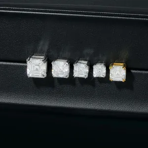Vue macro de cinq tailles de boucles d'oreilles moissanite taille émeraude sur cuir noir.