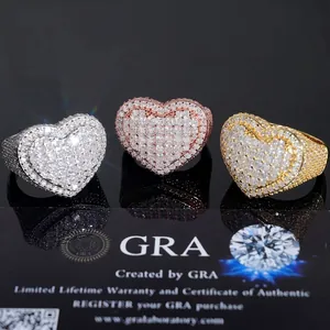Detailed view of hip-hop style heart-shaped moissanite rings in three gold tones