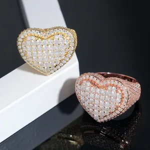 Close-up detail of iced out heart-shaped rings with princess-cut moissanite stones