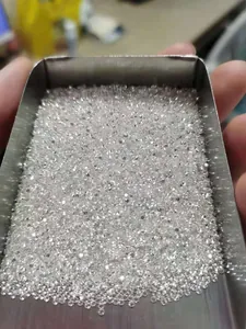 Close-up of sparkling D color moissanite melee stones in a tray for jewelry inlay accessories.