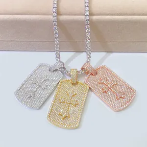 Close-up of three hip hop dog tag pendants in silver, gold, and rose gold with moissanite