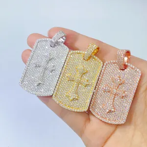 Detailed view of three iced out moissanite cross dog tag pendants in mixed metal tones